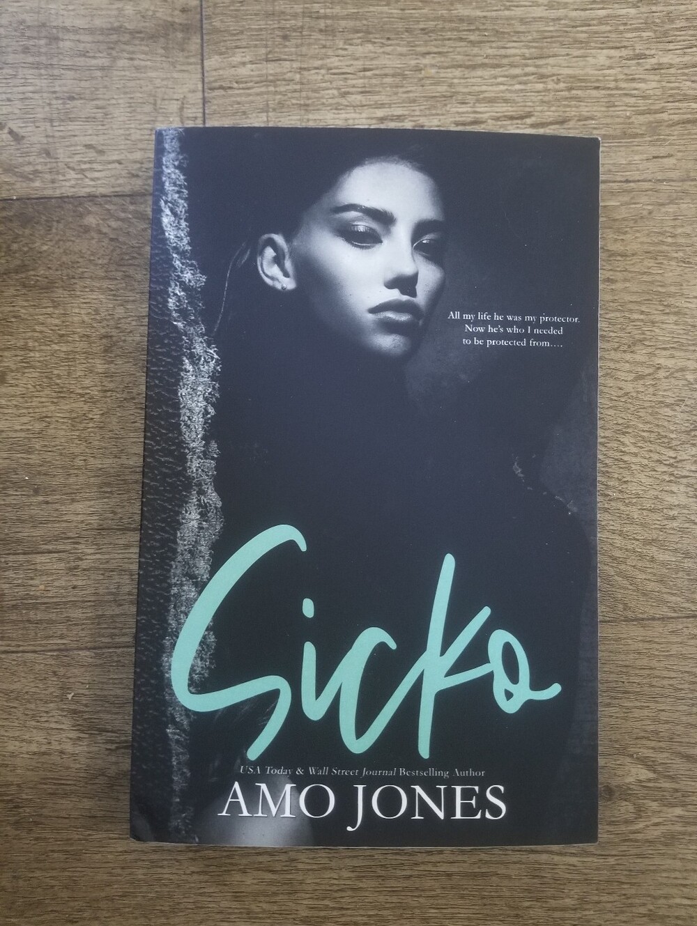 Sicko by Amo Jones — Black Cover with Teal Title